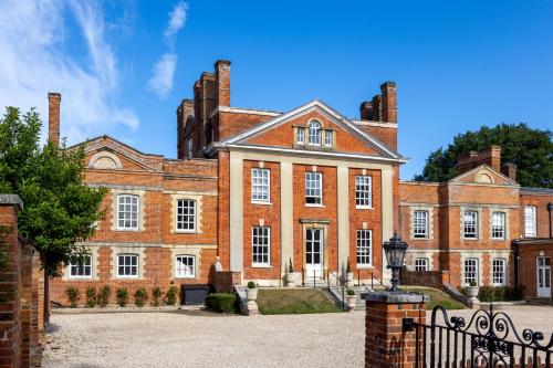 a large red brick building with two chimneys at Warbrook House Heritage Hotel in Hook
