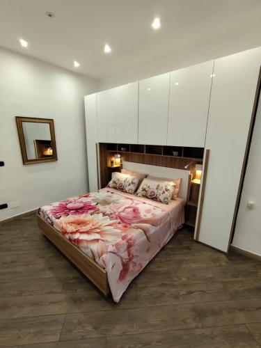 a bedroom with a large bed with flowers on it at Casa Borgo&Mare - Barletta in Barletta