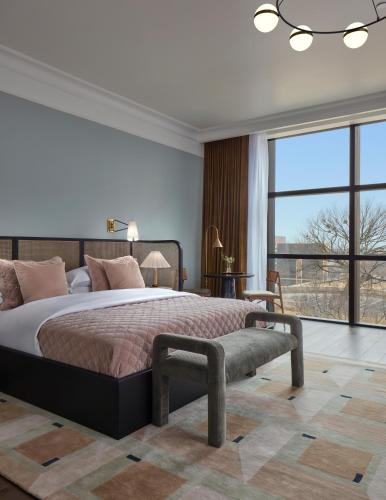 a bedroom with a large bed and a large window at Citizen House Hotel in Oklahoma City
