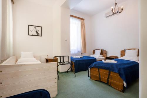 a hospital room with two beds and a sink at Renegade Hotel in Siófok