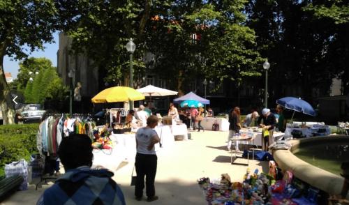 a group of people at an outdoor market in a park at Owls Hostel Ribeiro in Porto