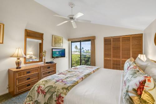 a bedroom with a bed and a ceiling fan at Wailea Elua 808 - Scenic Ocean Views, Classic Wailea Charm, Central AC, Wi-Fi in Wailea