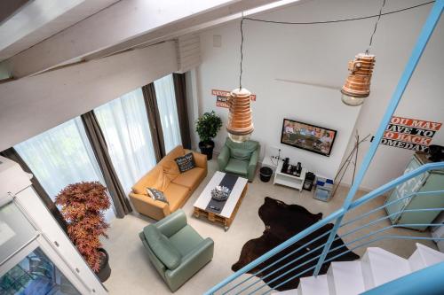 an overhead view of a living room with a staircase at Renegade Hotel in Siófok