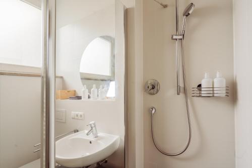 a bathroom with a shower and a sink at MARAL Loft München Bogenhausen in Munich