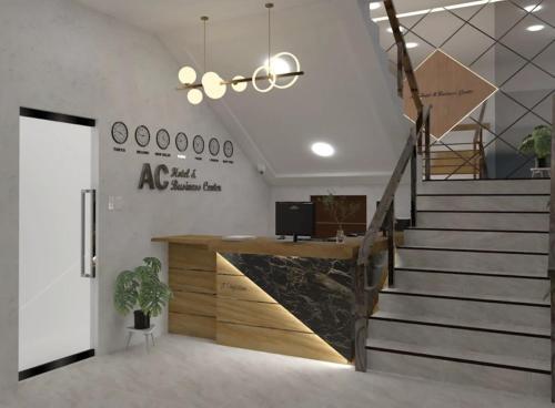 an office with a staircase and a reception desk at AC Cosy Hotel in Lala