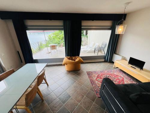 a living room with a couch and a table at Appartamento 5 Terre in Orta San Giulio