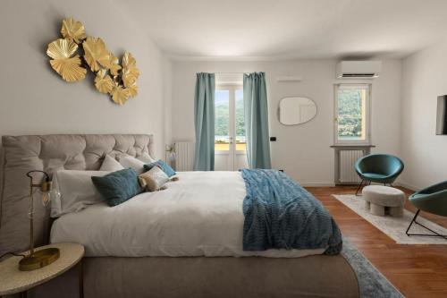 a bedroom with a large bed and a large window at Luxury townhouse with panoramic Como lake views by Aura Luxury Collection in Carate Urio