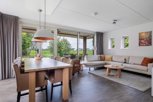 a living room with a table and a couch at Buitengoed Rheelanden in Ansen