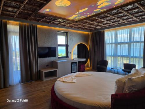 a hotel room with a large bed and a television at Toka Hotel Restaurant in Pogradec