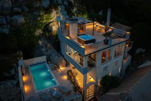an aerial view of a house with a swimming pool at Holiday Home La Montagna - Private Heated Pool in Lokva Rogoznica