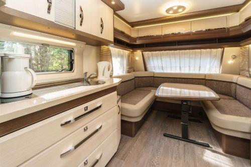 an rv kitchen with a sink and a counter at Urlaub im Wohnwagen mitten im Wald in Lütow
