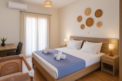 a bedroom with a bed with two candles on it at Harma Villa with Private Pool in Roúpai