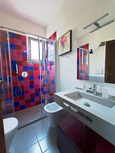 a bathroom with a sink and a toilet and a shower at Al Castelluccio in San Vincenzo