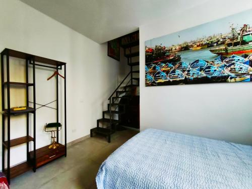 a bedroom with a bed and a painting on the wall at Al Castelluccio in San Vincenzo