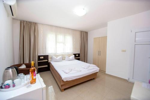 a hotel room with a bed and a sink at Rama Residence in Budva
