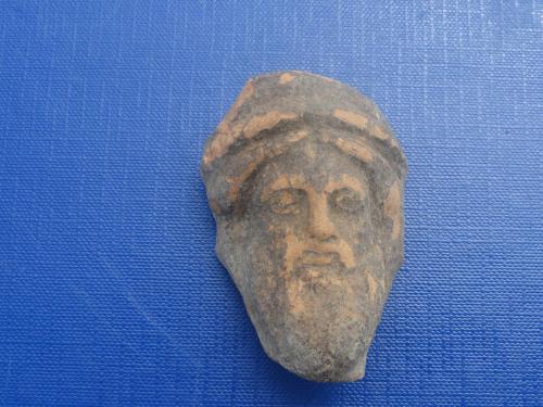 a artifact of a head on a blue background at Le Grotte di Sileno in Castellaneta