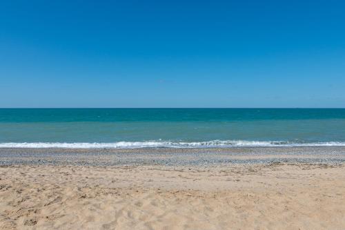a sandy beach with the ocean in the background at Airport Black Sea Hotel & Restaurant in Arnavutköy