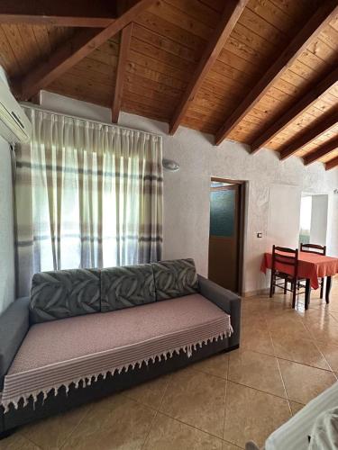 a living room with a couch and a table at Villa Nava Ksamil in Polisi i Vogël