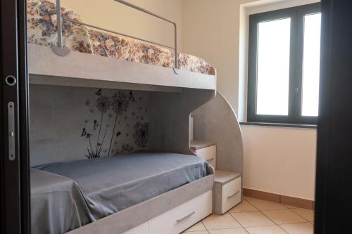 Katil atau katil-katil dalam bilik di Villa Dino, casa con vista panoramica a 8 minuti dal centro di Diamante