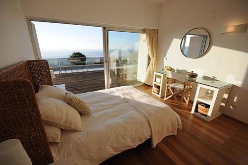 ein Schlafzimmer mit Bett und Blick auf das Meer in der Unterkunft Tasteful Caminha Villa 4 Bedrooms Villa Laginhas Modern Furnishings in Caminha