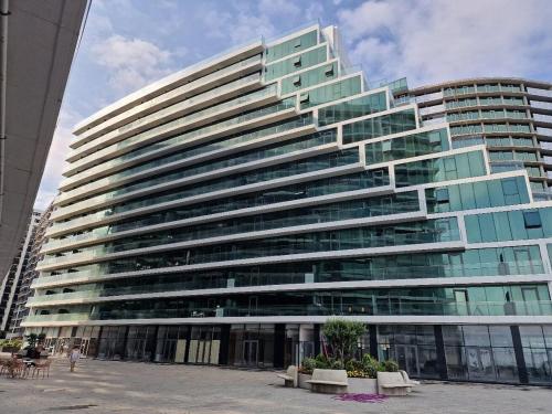 a large office building with a lot of windows at Charming Batumi Apartment with City and Water Views in Batumi
