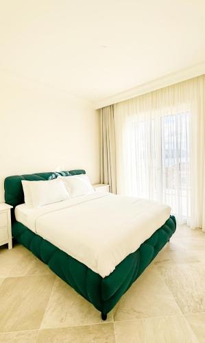 a large bed in a room with a window at One Bedroom Sea View Apartment - Lustica Marina in Radovici