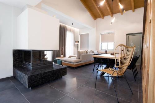 a living room with a fireplace and a table at Exquisite Crete Villa Villa Kleanthi 4 Bedroom Private Pool Panoramic in Stalos