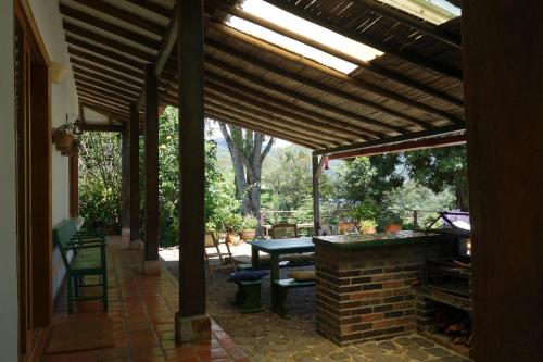 a patio with a table and a brick fireplace at El Romeron Casa de Campo in San Francisco