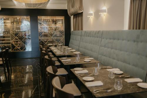 a long row of tables and chairs in a restaurant at Palmar Boutique Hotel in Campofelice di Roccella