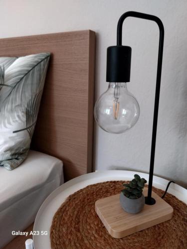 a lamp on top of a table next to a bed at ΑΡΜΟΝΙΑ-Harmony in Veria