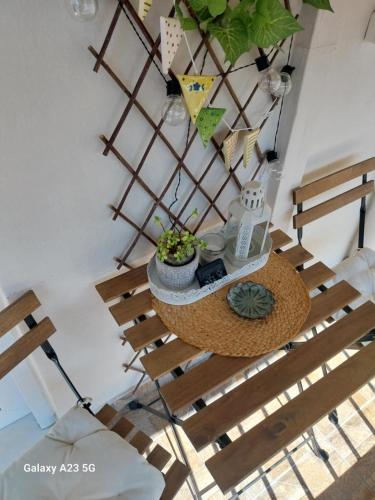 a table with plants on top of a wooden chair at ΑΡΜΟΝΙΑ-Harmony in Veria