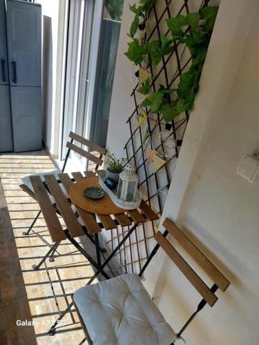 a table and chairs in a room with a plant at ΑΡΜΟΝΙΑ-Harmony in Veria