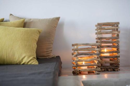 a stack of books sitting next to a couch at Elegant Astypalaia Villa Villa Bianca 2 Bedrooms Hot Tub & Beautiful Sea in Astypalaia Town