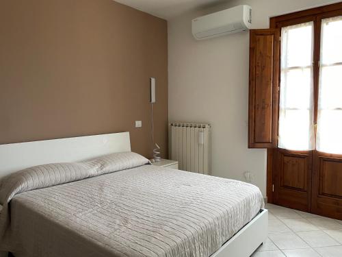 a bedroom with a bed and a window at B&B il Castelletto Siena in Montaperti
