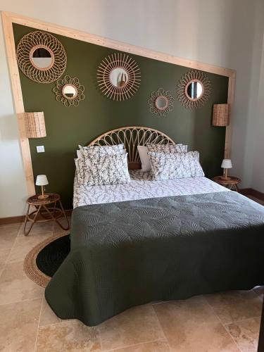 - une chambre avec un grand lit et des miroirs au mur dans l'établissement La Bastide de Grosille, à Savasse