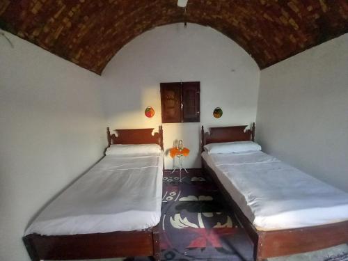 two beds sitting in a room with a room withthritisthritisthritisthritisthritisthritis at Soul House in Jazīrat Fīlah