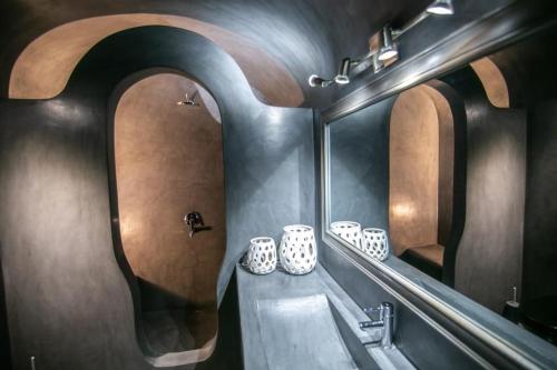 a bathroom with a sink and two mirrors at Luxury Santorini Villa Ocean Breeze Villa 2 Bedrooms Sea & Caldera View Jacuzzi & Plunge Oia in Thólos