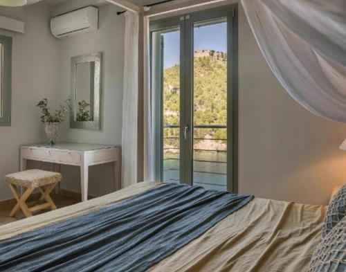 a bedroom with a bed and a desk and a window at Magnificent Kefalonia Villa Villa Chalker 3 Bedrooms Seafornt Spectacular Sea Views Private Outdoor Pool Assos in Asos