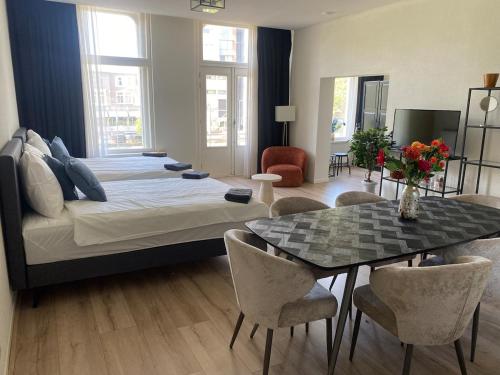 a bedroom with a bed and a table with chairs at Cozy and best location! 6 person in Rotterdam