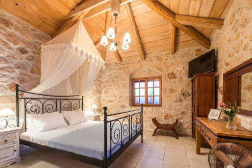 a bedroom with a bed and a wooden ceiling at Extravagant Zante Villa Villa Purple Great Sea Views 3 Bedrooms Agios Nikolaos in Koríthion