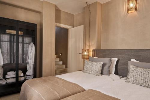 a bedroom with a large bed and a staircase at Luxury Naxos Villas Luxury Villa Air Conditioning Private Pool 2 Bedrooms Stelida in Naxos Chora