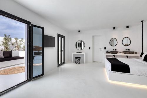 a white bedroom with a bed and a large window at Phenomenal Mykonos Villa 6 Bedrooms Villa Paradise View Panoramic Sea Views & Private Infinity Pool Psarou Beach in Psarou