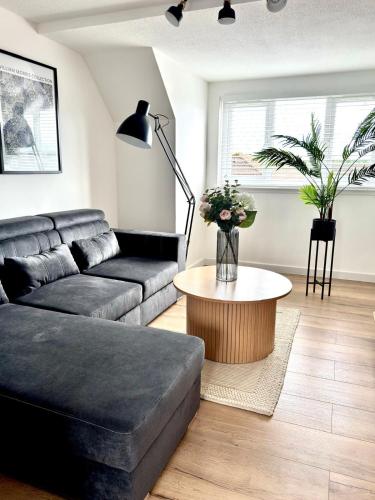 a living room with a couch and a coffee table at Almondvale Apartment in Livingston