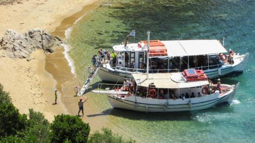 a group of people on a boat in the water at Extravagant Zante Villa Villa Crystal Great Sea Views 3 Bedrooms Agios Nikolaos in Koríthion