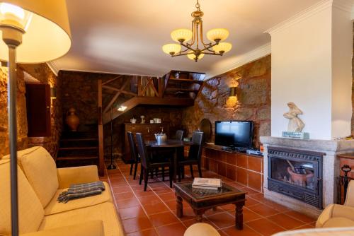 a living room with a couch and a fireplace at Quinta de Silvares in Armamar