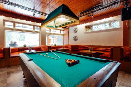 a billiard table in a room with a pool table at Hotel Sachticka in Banská Bystrica