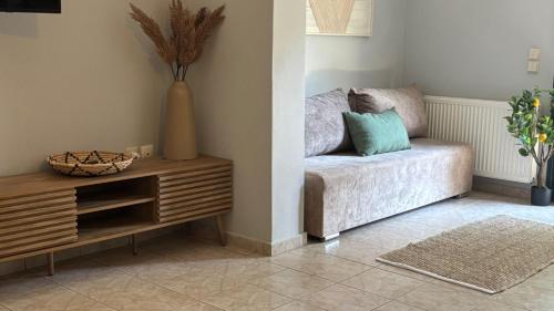 a living room with a couch and a table at Diamond Corfu Viros Suite in Bastoúnion