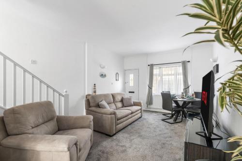 a living room with a couch and a chair at Little Wiston- With free parking in Worthing