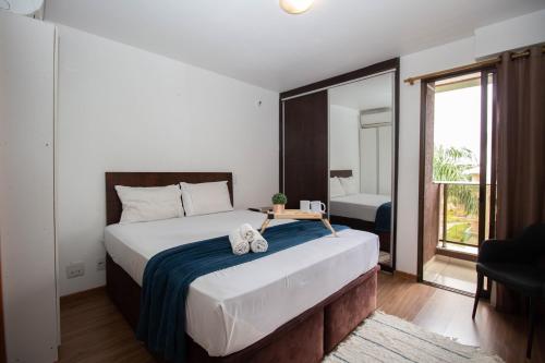 a bedroom with a large bed with a table on it at OZPED Flats Particulares Edifício Life Resort in Brasilia
