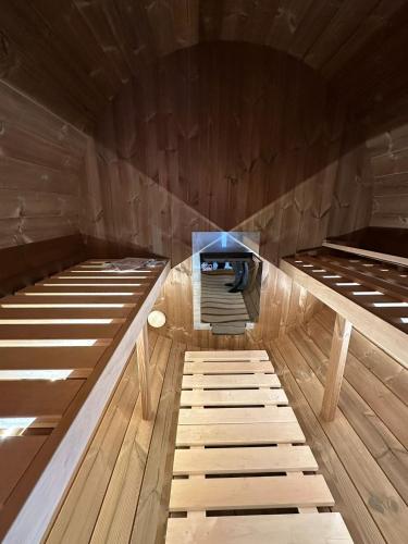 a room with three beds in a wooden room at Ferienwohnung mit Whirpool und Fasssauna - Medebach in Medebach